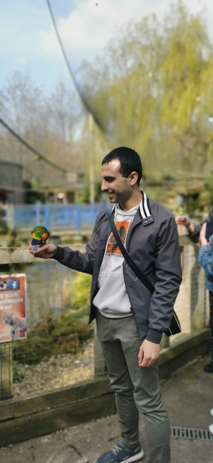 Adil Musa feeding the Rainbow Lorikeets