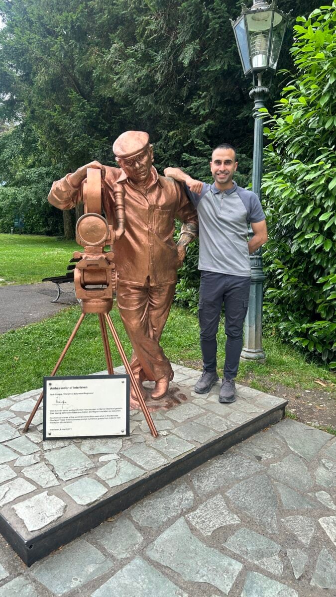 Adil Musa alongside Yash Chopra Statue