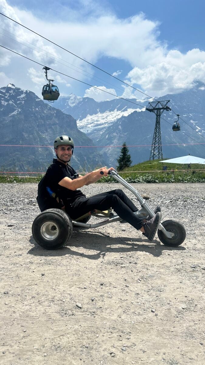 Adil Musa riding a mountain cart at Grindelwald First